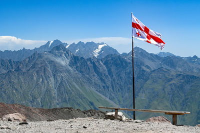 Low angle view of flag against mountain
