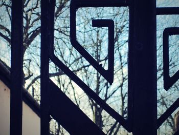 Close-up of railing against trees