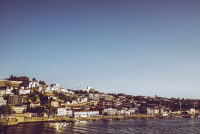 Town by sea against clear sky