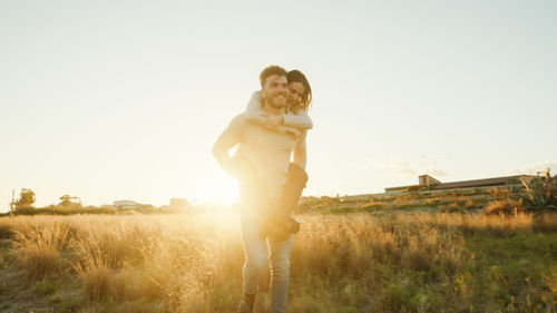 Boy and girl couple hug and walk together in the natural park