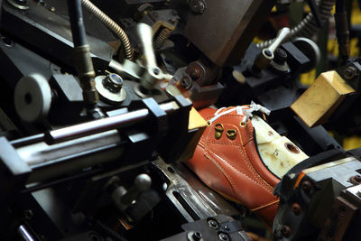 High angle view of leather shoe on machinery at factory