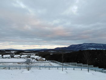 Snow covered field against sky