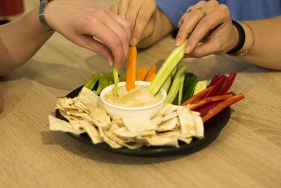 Close-up of hand holding food on table