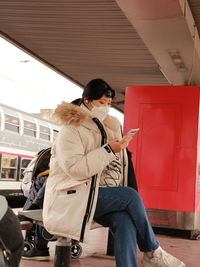 Side view of woman using mobile phone