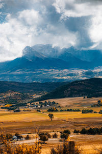 Scenic view of landscape and mountains against sky