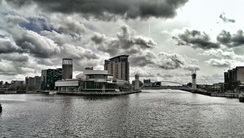 Buildings against cloudy sky