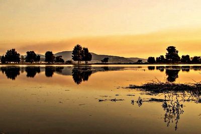 Scenic view of lake at sunset