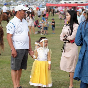 Rear view of people standing on grassland