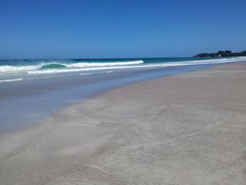 Scenic view of beach against clear sky