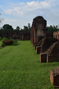 Old ruin building on field against sky