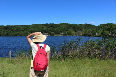 Rear view of woman looking at sea against sky