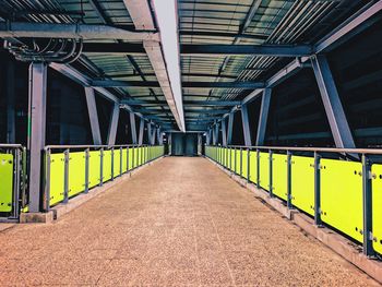 Empty footbridge in city at night