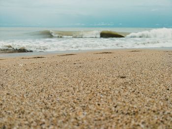 Surface level of beach against sky