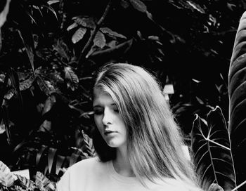 Beautiful woman standing against plants