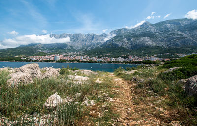 Scenic view of lake and mountains against sky