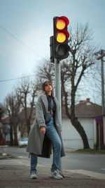 Full length of woman standing on road