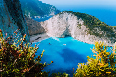 Scenic view of rocky cliff by sea