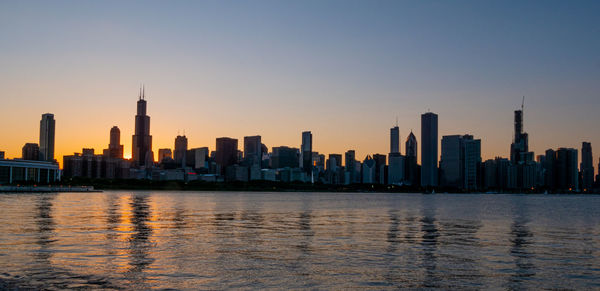 View of buildings in city at sunset