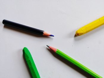 High angle view of colored pencils on white background