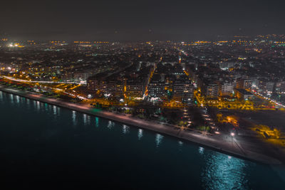 Aerial view of city lit up at night