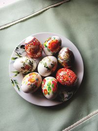 High angle view of multi colored eggs on table