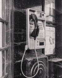 Man using mobile phone by window