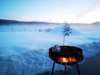 Scenic view of snow covered field against sky