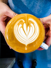 Midsection of man holding coffee cup