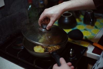 Midsection of person preparing food in kitchen