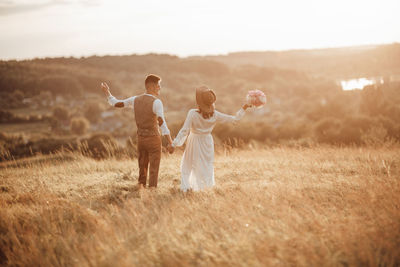 Friends standing on field