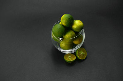 Close-up of fruits on table against black background