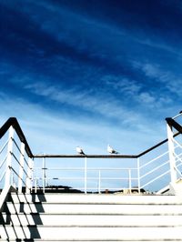 Low angle view of staircase against blue sky