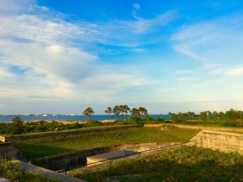 Scenic view of landscape against cloudy sky