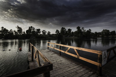 Pier over lake against sky