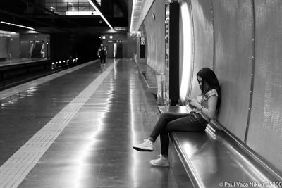 People in illuminated corridor