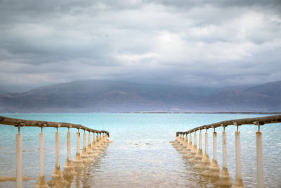 Pier over sea against sky