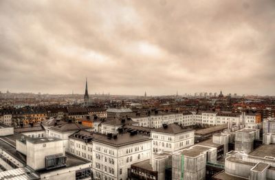 Cityscape against cloudy sky