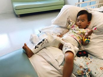 Young boy with leg cast in hospital bed