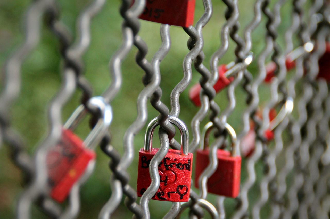 large group of objects, in a row, metal, red, abundance, close-up, hanging, variation, selective focus, focus on foreground, padlock, protection, still life, lock, security, repetition, safety, arrangement, order, no people