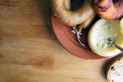 Portuguese cheese from azeitao and smoked sausages alheira and chorizo on wooden board