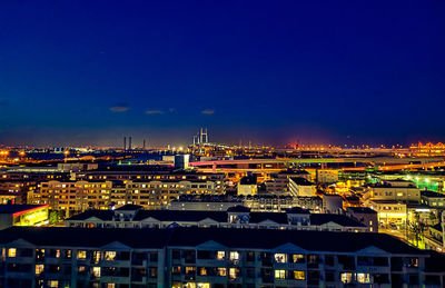 High angle view of illuminated buildings in city at night