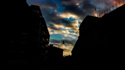 Silhouette cityscape against sky during sunset