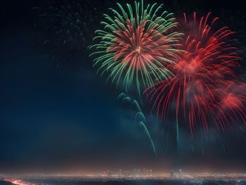 Low angle view of firework display at night