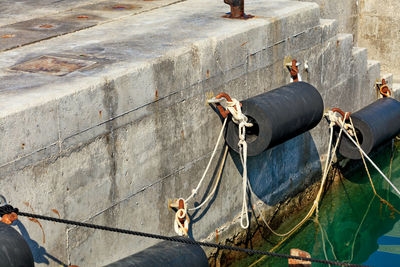 Bollards and wing wharf on an old concrete sea pier.