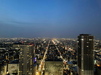 Illuminated cityscape against sky