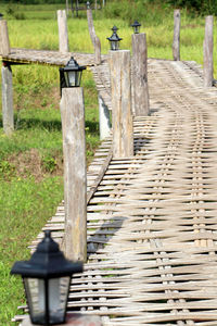 Empty chairs on footpath by fence