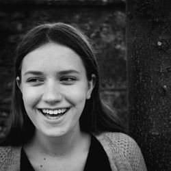 Close-up of cheerful young woman looking away outdoors