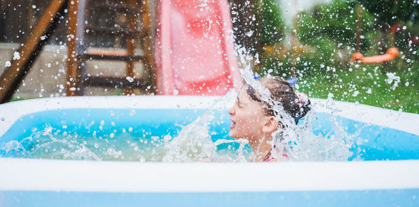 Portrait of happy boy in swimming pool