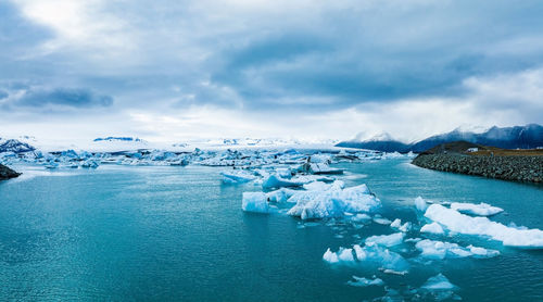 Scenic view of icebergs in jokulsarlon glacier lagoon, iceland, at dusk.