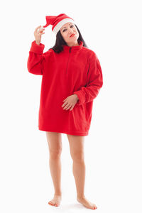 Portrait of young woman standing against white background